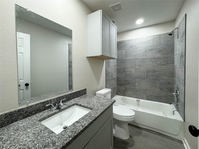 bathroom featuring toilet, visible vents, shower / washtub combination, and vanity