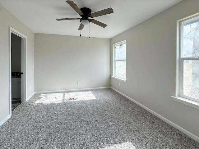 carpeted empty room with a ceiling fan and baseboards