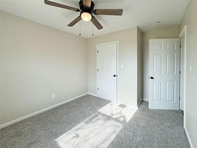 unfurnished bedroom featuring ceiling fan, baseboards, and carpet flooring