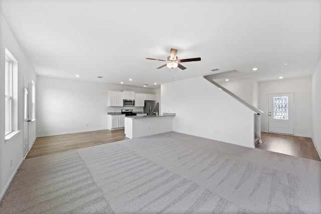 unfurnished living room featuring light wood-style floors, visible vents, a ceiling fan, and recessed lighting