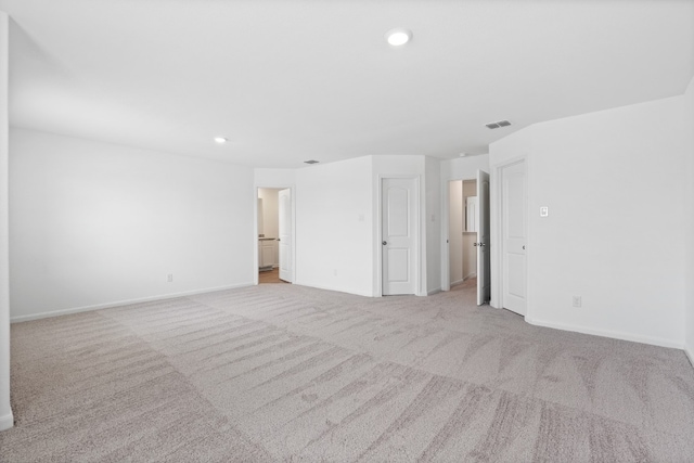 empty room featuring recessed lighting, visible vents, light carpet, and baseboards