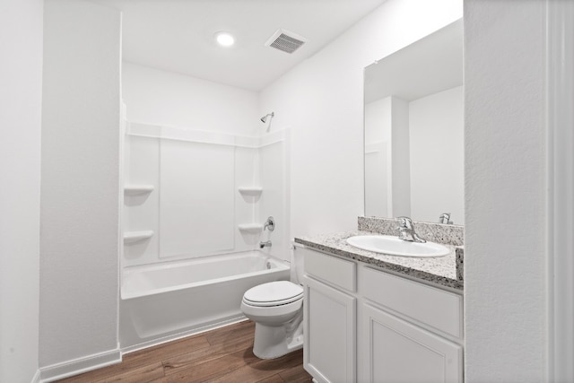 bathroom with bathtub / shower combination, toilet, wood finished floors, vanity, and visible vents