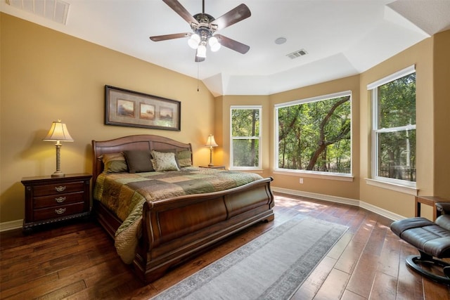 bedroom with multiple windows, dark wood-style flooring, and visible vents