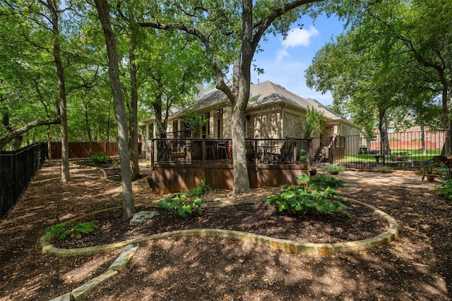 back of property featuring a fenced backyard and a wooden deck