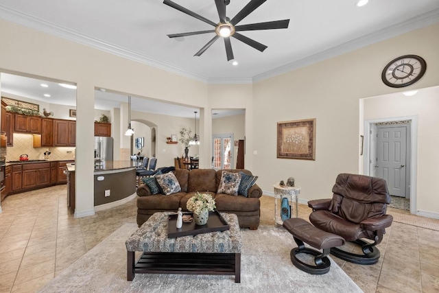 living room featuring ceiling fan, light tile patterned floors, arched walkways, and crown molding