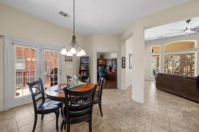 dining area featuring ceiling fan with notable chandelier, visible vents, and baseboards