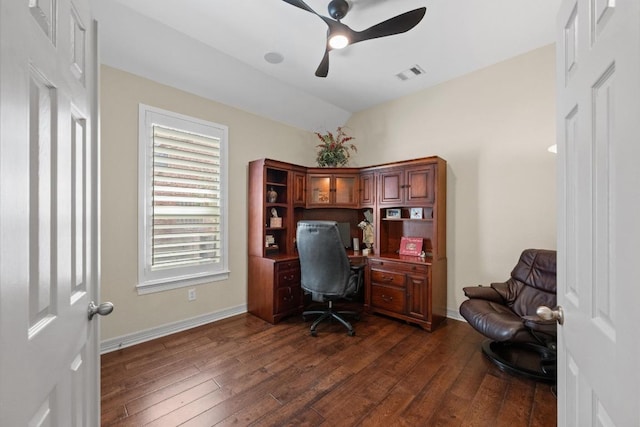 office featuring visible vents, dark wood finished floors, baseboards, ceiling fan, and vaulted ceiling