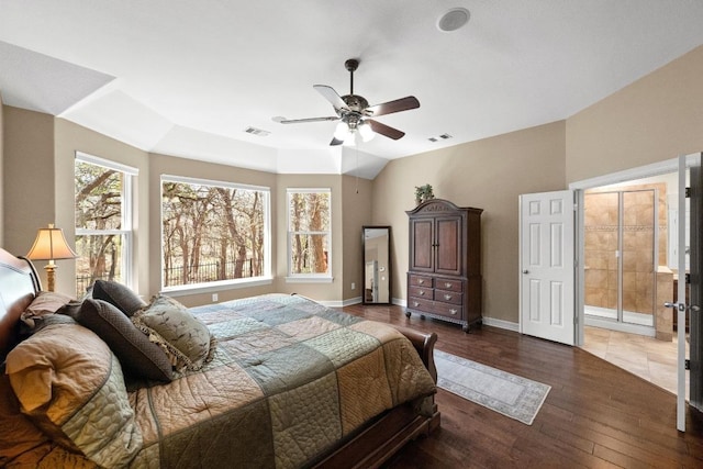 bedroom with visible vents, vaulted ceiling, baseboards, and wood finished floors