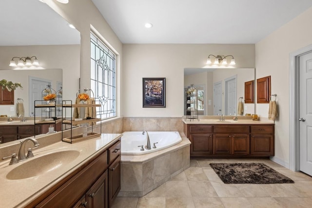 bathroom featuring a bath, two vanities, and a sink