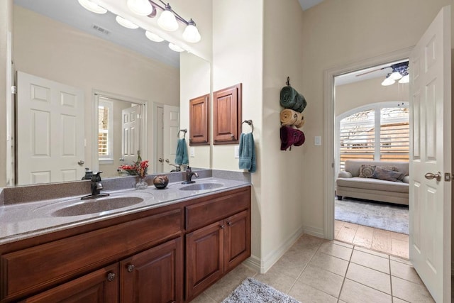 full bathroom featuring double vanity, tile patterned flooring, visible vents, and a sink