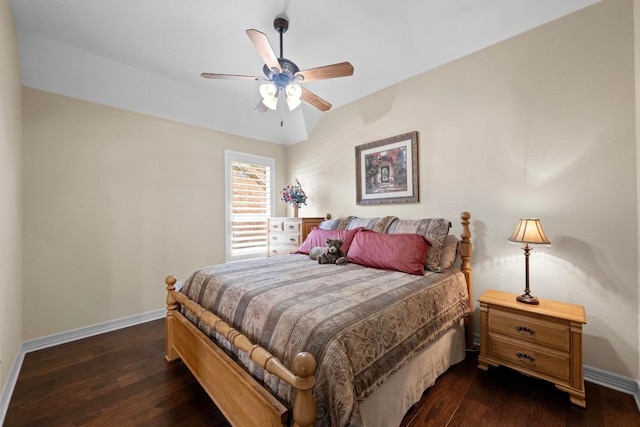 bedroom featuring lofted ceiling, dark wood-style flooring, and baseboards