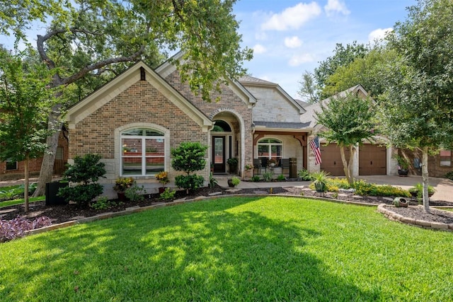 view of front of property featuring a garage, a front yard, brick siding, and driveway