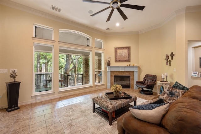 living room featuring tile patterned flooring, a fireplace, visible vents, and crown molding