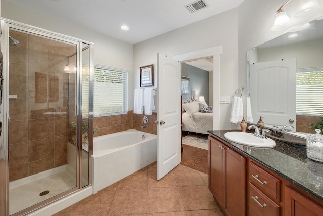 ensuite bathroom with a stall shower, ensuite bath, visible vents, and tile patterned floors