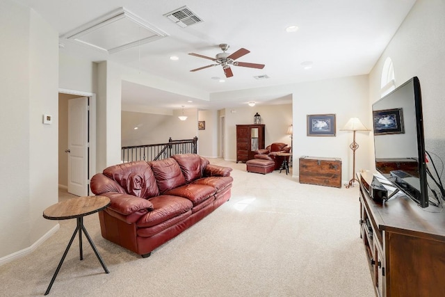 living area with attic access, light colored carpet, visible vents, and recessed lighting