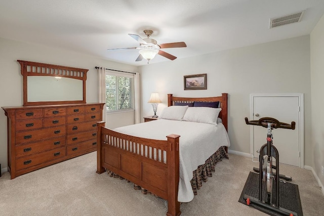 bedroom with visible vents, ceiling fan, and light carpet