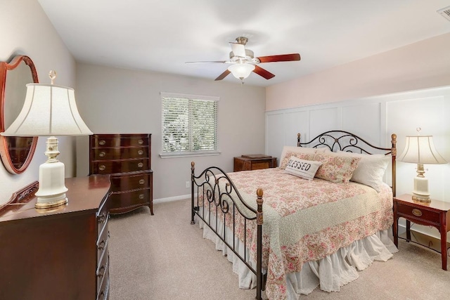 carpeted bedroom with ceiling fan, visible vents, and a decorative wall