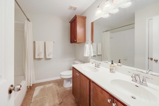 bathroom with toilet, visible vents, a sink, and tile patterned floors