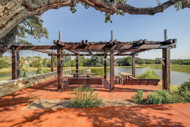 view of home's community with a water view and a pergola