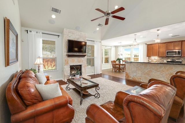 living area featuring plenty of natural light, visible vents, and wood finished floors