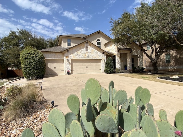 view of front of home featuring a garage, stone siding, concrete driveway, and stucco siding