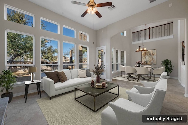 interior space with ceiling fan with notable chandelier and visible vents