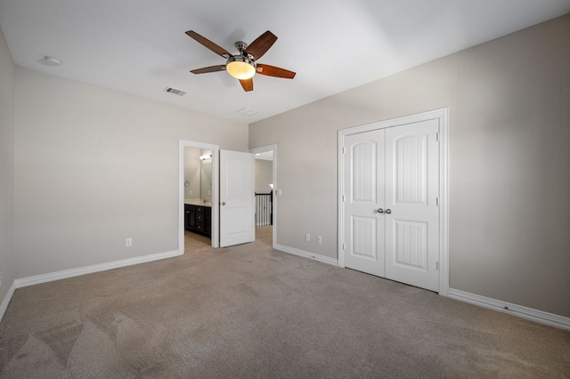 unfurnished bedroom with carpet, visible vents, and baseboards