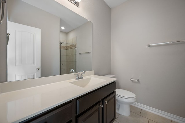 full bathroom featuring toilet, a stall shower, vanity, tile patterned flooring, and baseboards