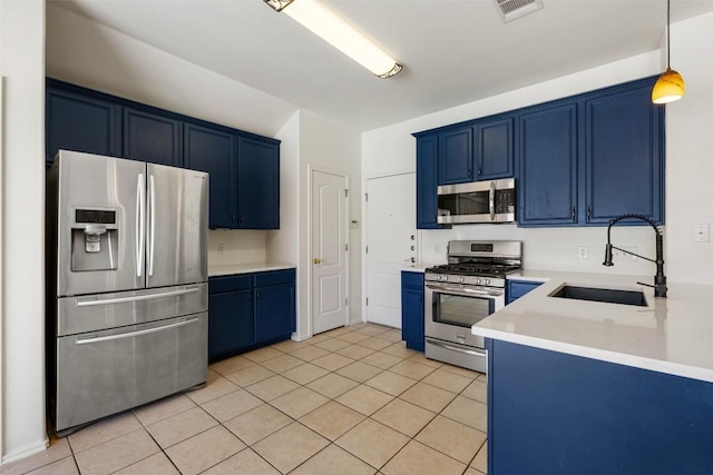 kitchen featuring blue cabinetry, visible vents, appliances with stainless steel finishes, and a sink