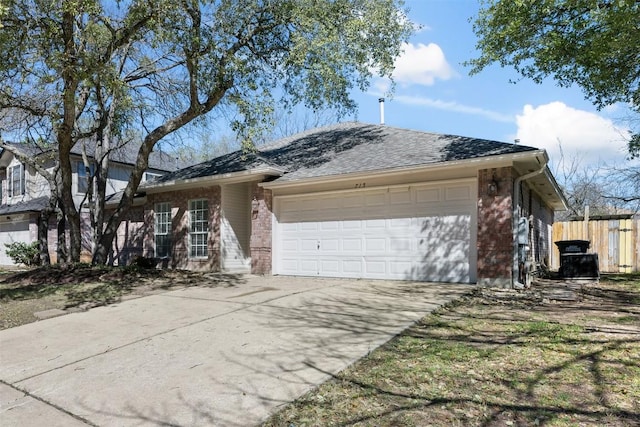 ranch-style house with a garage, concrete driveway, brick siding, and fence