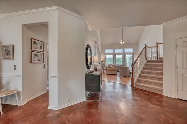 foyer entrance featuring baseboards, ceiling fan, stairway, crown molding, and concrete floors