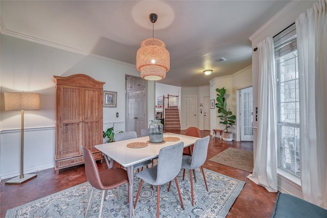 dining room featuring visible vents, crown molding, and stairway