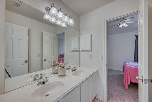 ensuite bathroom with visible vents, connected bathroom, a sink, and double vanity