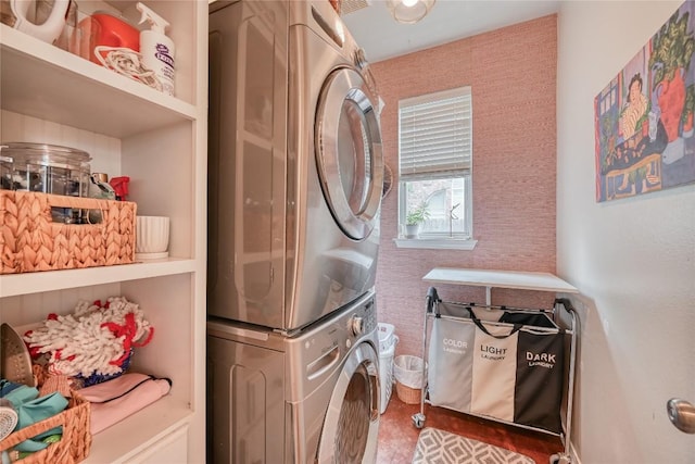 laundry area with laundry area and stacked washer / dryer