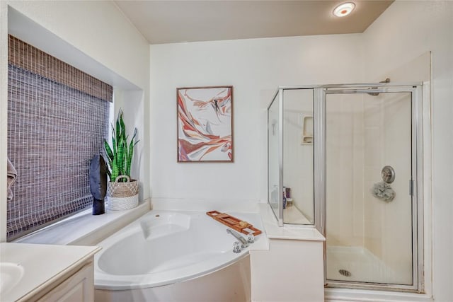 full bath featuring a stall shower, vanity, and a bath