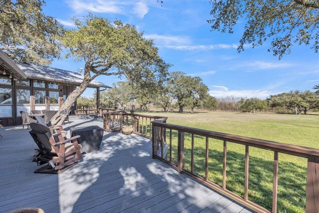 wooden terrace featuring a yard