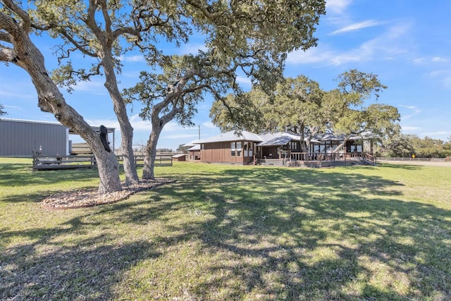 view of yard with fence and a wooden deck