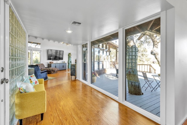 interior space with visible vents, wood finished floors, and floor to ceiling windows