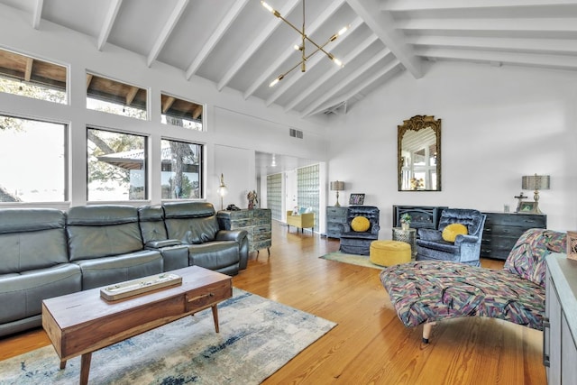 living room with beam ceiling, wood finished floors, visible vents, and high vaulted ceiling