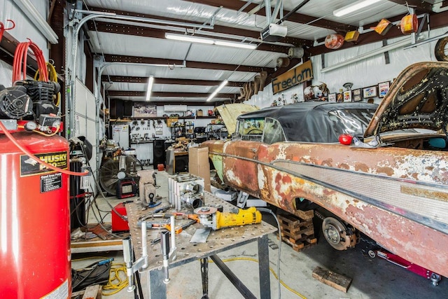 garage with a workshop area and a garage door opener