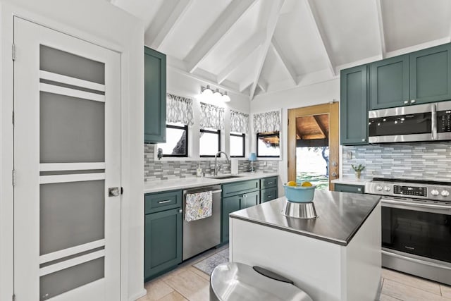 kitchen featuring tasteful backsplash, appliances with stainless steel finishes, green cabinets, and a sink