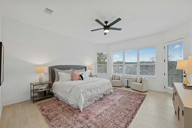 bedroom featuring light wood-style flooring, a ceiling fan, baseboards, visible vents, and access to exterior