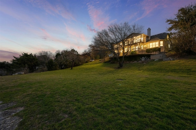 view of yard at dusk