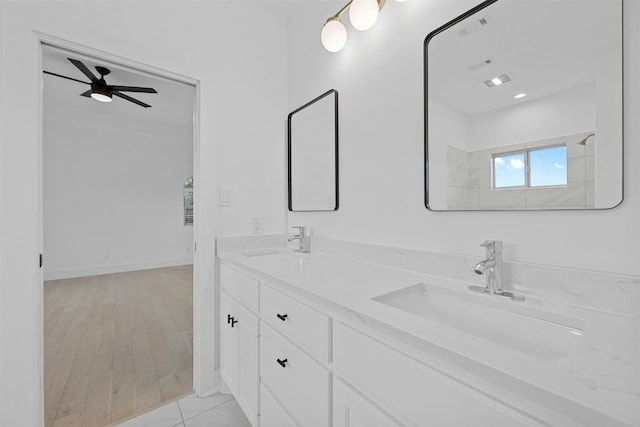 full bathroom with double vanity, a sink, ceiling fan, and visible vents