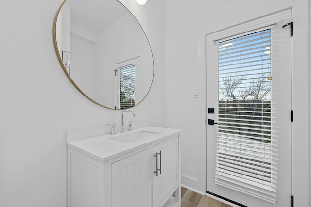 bathroom with vanity and wood finished floors