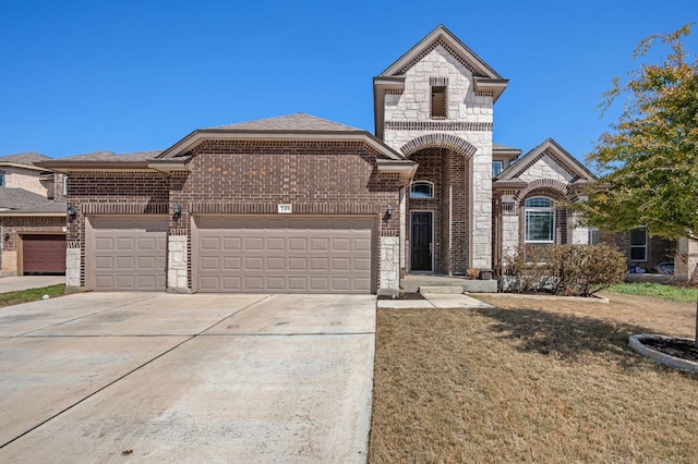 french country style house with a garage, driveway, stone siding, a front lawn, and brick siding