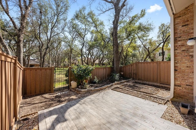 view of patio / terrace with a fenced backyard, a gate, and a wooden deck