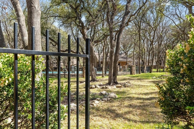 view of yard with fence and a pool