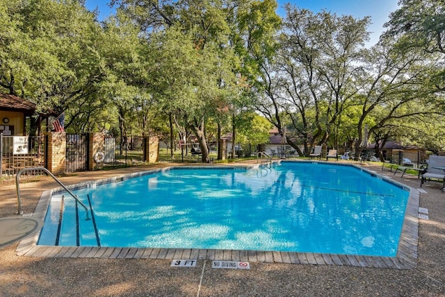 pool featuring a patio area and fence