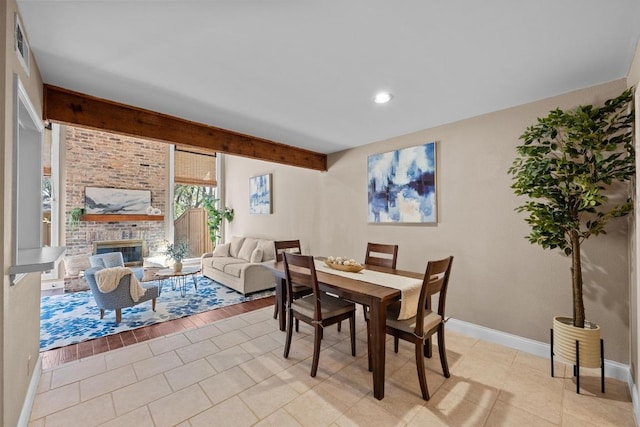 dining room with light tile patterned floors, baseboards, visible vents, a fireplace, and recessed lighting